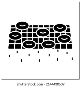 Donuts glyph icon. Steel wire rack resting and oil draining doughnuts. Concept of sweet pastry home cooking and baking. Cookbook instruction. Filled flat sign. Isolated silhouette vector illustration
