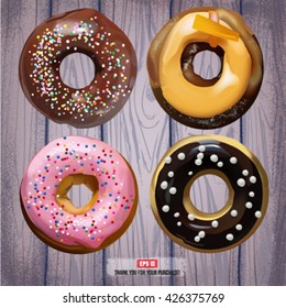Donuts on the wood texture. Vector EPS 10.