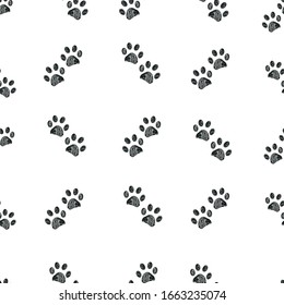 Doodle black paw prints trace of cats seamless vector pattern for fabric design