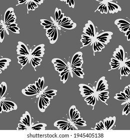 Doodle black and white butterflies and light dots on a gray background. Insects. Seamless exotic summer pattern. Suitable for wallpaper, textile, packaging.