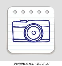 Doodle Camera icon. Blue pen hand drawn infographic symbol on a notepaper piece. Line art style graphic design element. Web button with shadow. Photography, taking pictures concept. 
