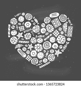 Doodle cookies, waffles and candies composed in heart shape.