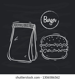 doodle or hand drawn style of burger with paper bag on blackboard background