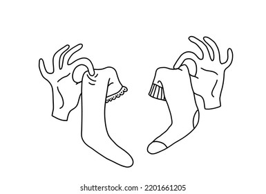 Doodle hands hold different socks with spread fingers. Hand drawn outline of hands with unpaired cotton socks. Vector illustration of warm clothes for feet isolated on white background.