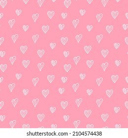Doodle hearts seamless pattern. Cute hearts isolated on pastel pink background.