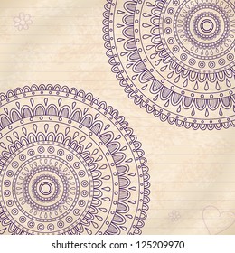 Doodle mandala on vintage paper. Vector image.