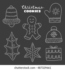 Doodle outline Christmas cookies with decor isolated on the blackboard.