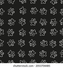 Doodle paw print seamless fabric design black and white background pattern