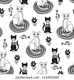 Doodle seamless pattern with funny cats on a white background. Hand-drawn vector illustration. 
