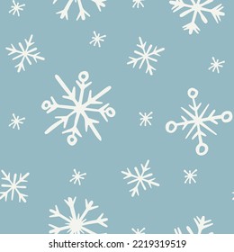 Doodle snowflakes seamless pattern. White snowflakes on powder blue background. New Year and Christmas pattern for gift wrapping, wallpapers, textile and fabric.