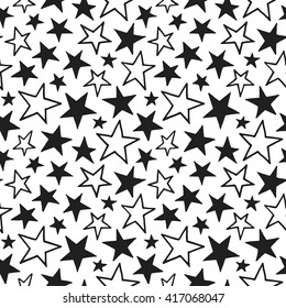 Doodle style stars of different size seamless vector pattern. Black and white cosmic, space background. Free hand drawn star shapes. Simple cosmical monochrome texture.