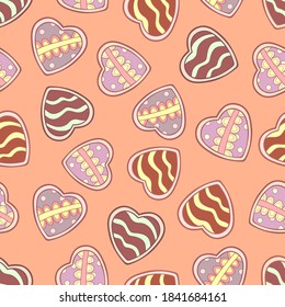 Doodle sweets in the form of hearts with decorative simple elements on pale pink background. Seamless tasty winter pattern. Suitable for wrapping, textile, wallpaper.