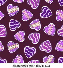 Doodle sweets in the form of hearts with decorative elements on a dark red-purple background. Seamless tasty winter pattern. Suitable for wrapping, textile, wallpaper.