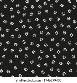Doodle white paw print seamless fabric design repeated pattern with black background