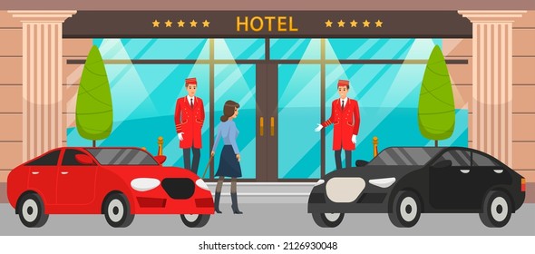 Doormen in red uniform next to door inviting to hotel. Girl with suitcase near entrance to building. Main front entrance to luxury hotel and premium cars. Staff and visitors near large building
