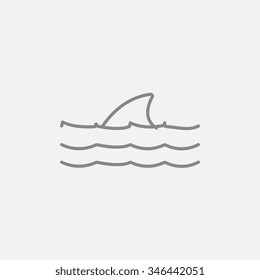 Dorsal shark fin above water line icon for web, mobile and infographics. Vector dark grey icon isolated on light grey background.