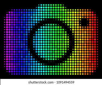 Dot impressive halftone photo camera icon in spectrum color variations with horizontal gradient on a black background. Color vector pattern of photo camera pictogram created from circle cells.