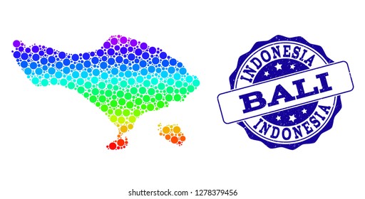 Dot rainbow map of Bali Island and blue grunge round stamp seal. Vector geographic map in bright rainbow gradient colors on a white background.