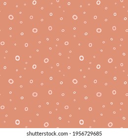 Dotted background pattern. Abstract neutral vector seamless repeat of hand drawn dots in a randomised design. Graphic resource for textile, stationery, scrapbooking and home decor projects.