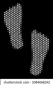 Dotted white human footprints icon on a black background. Vector halftone concept of human footprints symbol organized with spheric pixels.