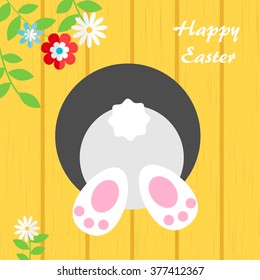 Down the rabbit hole. Happy Easter greeting card with escaping bunny