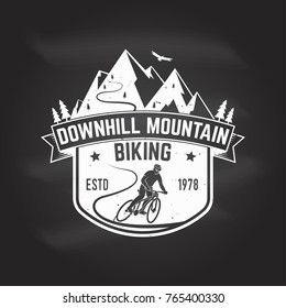 Downhill mountain biking. Vector illustration. Concept for shirt or logo, print, stamp or tee. Vintage typography design with man riding bike and mountain silhouette. Chalk drawing on a blackboard.