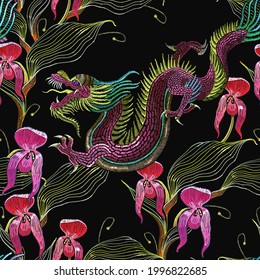 Dragons and beautiful tropical orchids. Classical embroidery template for clothes. Tropical seamless pattern vector