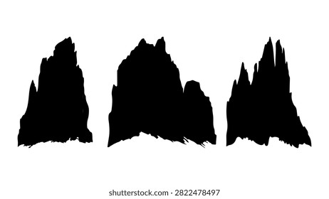 Dramatic silhouette of rugged mountain peaks with a clear sky background, emphasizing natural landscape and geological formations.