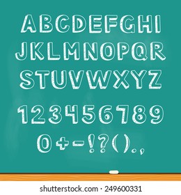 Drawing alphabet lettering on chalk blackboard