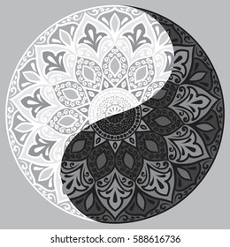 Drawing of a black and white mandala (round ethnic ornament) in shape of symbol yin yang