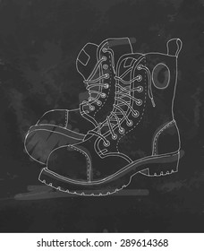 Drawing of boots on chalkboard. Vector illustration.
