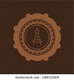 drawing compass icon inside badge with wooden background