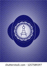 drawing compass icon inside emblem with jean background