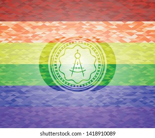 drawing compass icon inside emblem on mosaic background with the colors of the LGBT flag