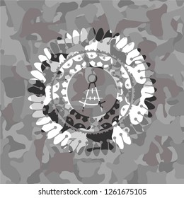 drawing compass icon inside grey camouflaged emblem