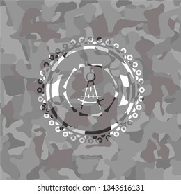 drawing compass icon inside grey camo emblem