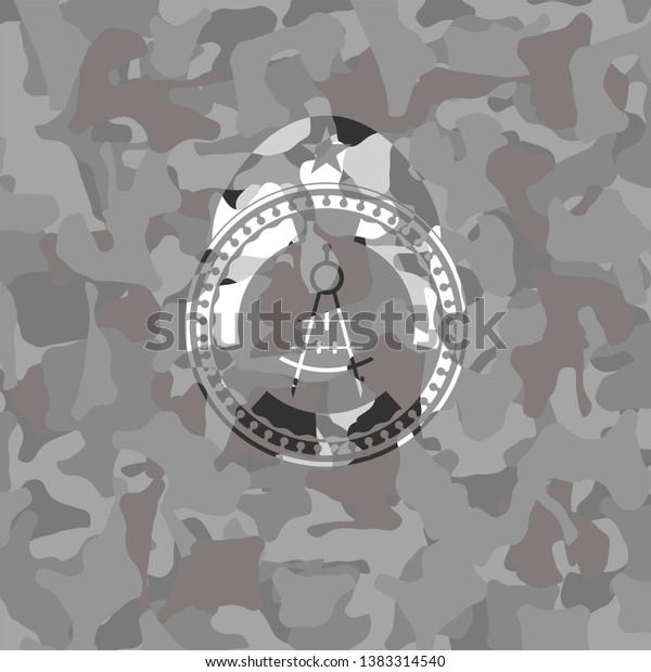 drawing\
compass icon inside grey camouflage\
emblem
