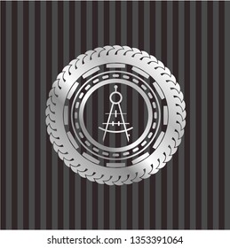drawing compass icon inside silvery emblem or badge