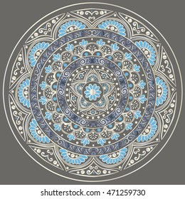 Drawing of a floral mandala in silver and blue colors on a dark gray background