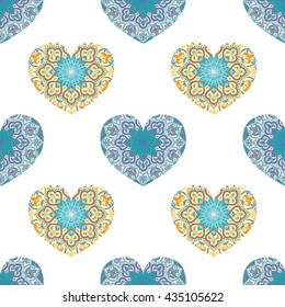 Drawing of a seamless pattern with hearts in blue and orange colors, with floral ethnic round ornament on a white background