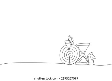Drawing of smart muslim businesswoman working with computer sit on target with chess knight and sandglass. Metaphor for business strategy, planning to achieve goal. Single line art style
