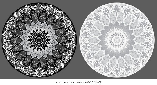 Drawing of a two black and white floral mandalas on a gray background. Hand drawn tribal vector stock illustration