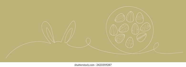 Drawn bunny ears and Easter eggs on green background