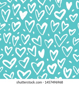 Drawn with a dry brush. Seamless pattern with hearts on a blue background. 