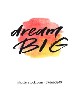 Dream big hand drawn lettering on watercolor splash in red and yellow colors.