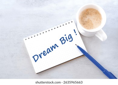 Dream Big - text words typography written on notebook with cup of coffee on table, life and business motivational inspirational concept