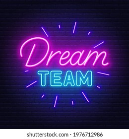 Dream Team neon sign on brick wall background.