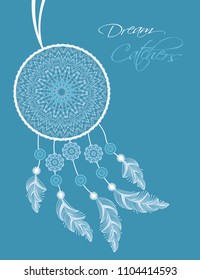 Dreamcatcher with feathers on a blue background