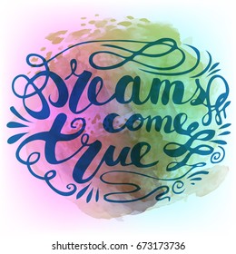 Dreams come true hand lettering phrase on watercolor imitation color splash. Modern calligraphy inspirational quote.