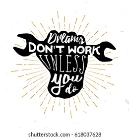 Dreams don't work unless you do - motivational and inspirational quote in vintage style inside the hand with wrench. Sun burst on the background.